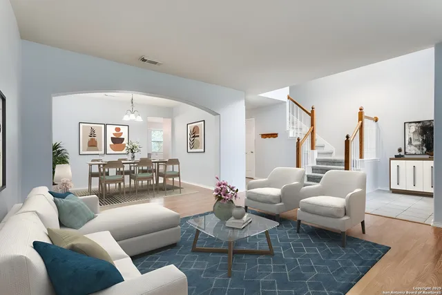 a living room with furniture and wooden floor