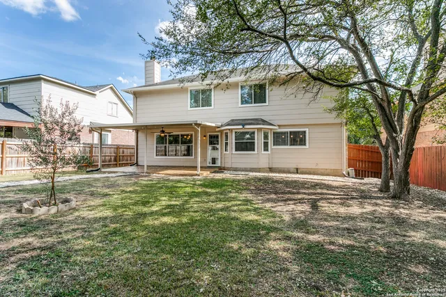 a house that has a tree in front of it