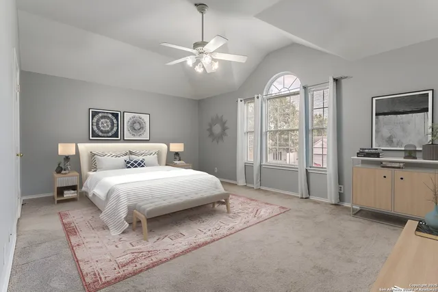 a spacious bedroom with a large bed and a chandelier
