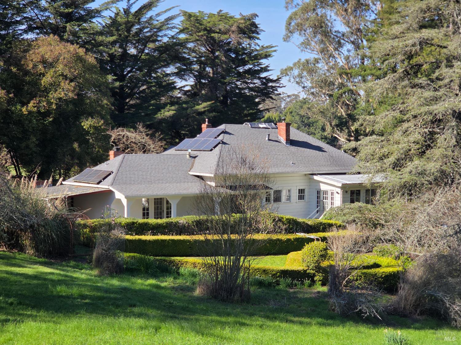 a front view of house with yard and green space