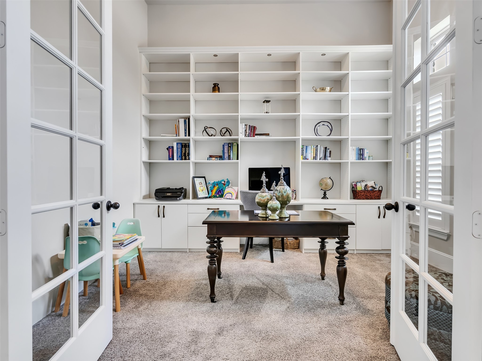 10302 Muir Peak Drive Rosharon, TX 77583 - Photo 5 of 40 Home office with French doors and built-in bookshelves along with natural lighting.