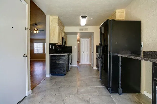 a view of a hallway to rooms and stairs