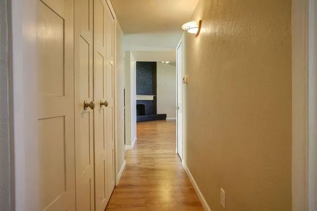 a view of a hallway with wooden floor