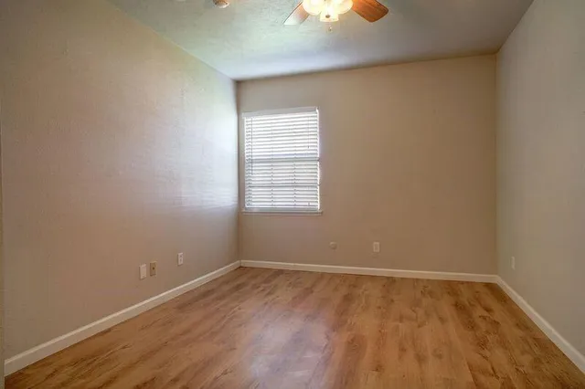 wooden floor and window in an empty room