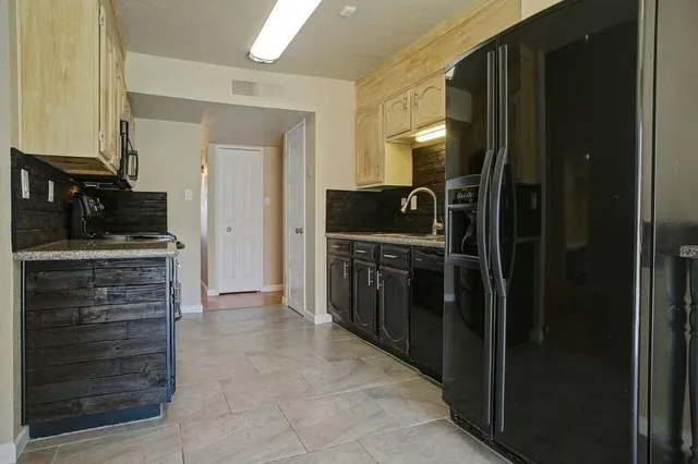 a kitchen with a refrigerator and a stove