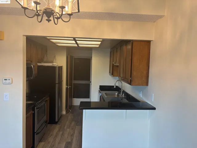 a kitchen with a refrigerator and a sink