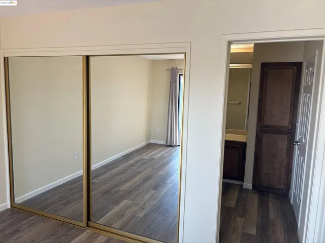 a view of a room with wooden floor