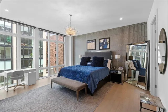 a bed room with a bed and a chair