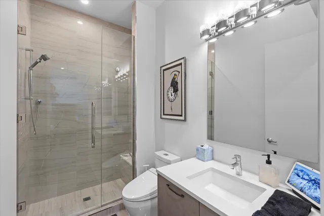 a bathroom with a sink toilet and shower