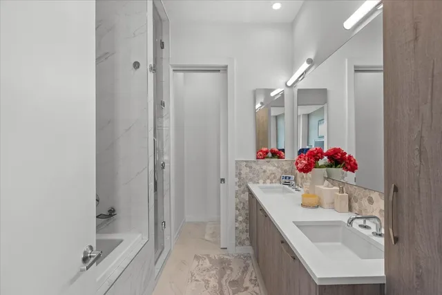 a bathroom with a sink vanity tub and shower
