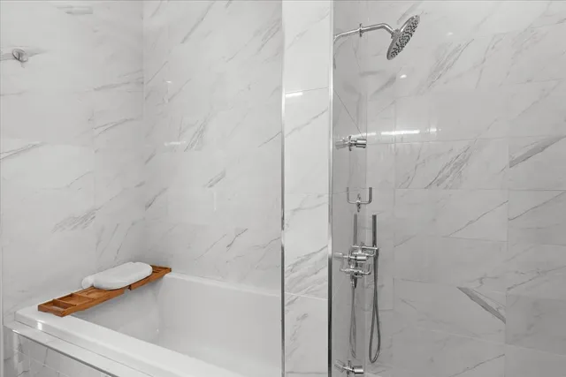 a bathroom with a tub and shower