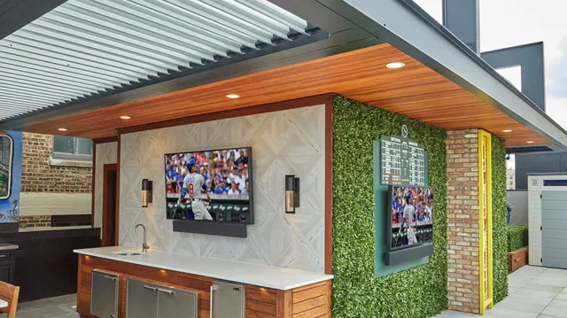 an outdoor living area with furniture and a flat screen tv