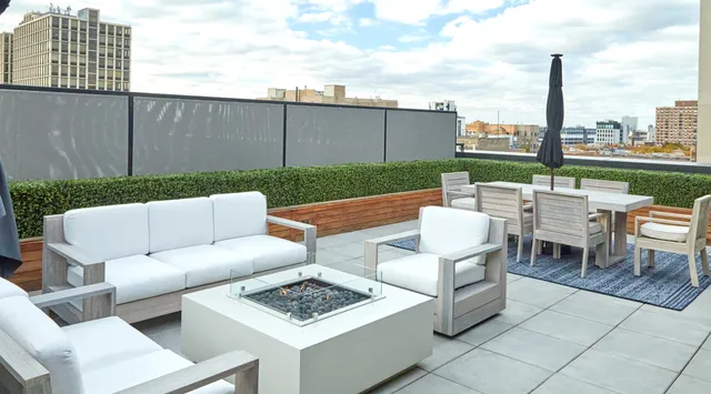 a view of a patio with couches and a table and chairs with potted plants