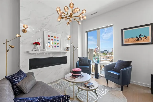 a living room with furniture and a chandelier