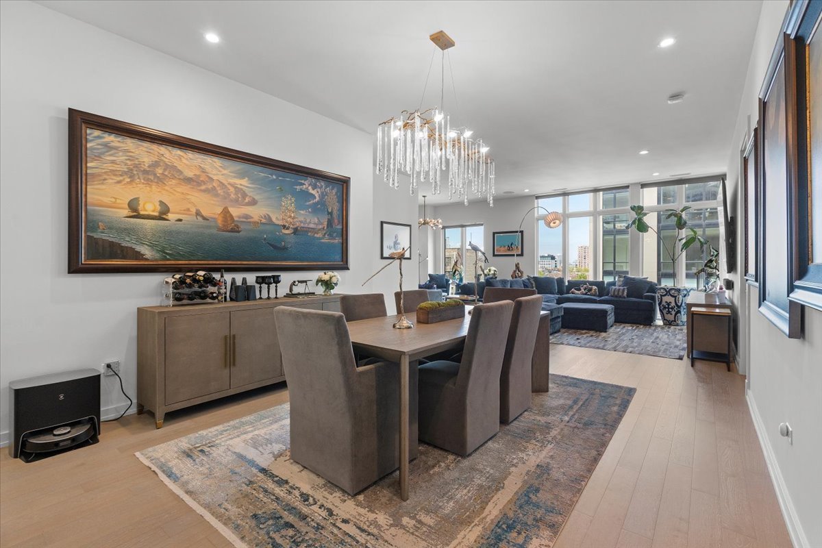 2773 North Hampden Court, Unit PH03 Chicago, IL 60614 - Photo 4 of 37 a view of a dining room with furniture a chandelier and wooden floor