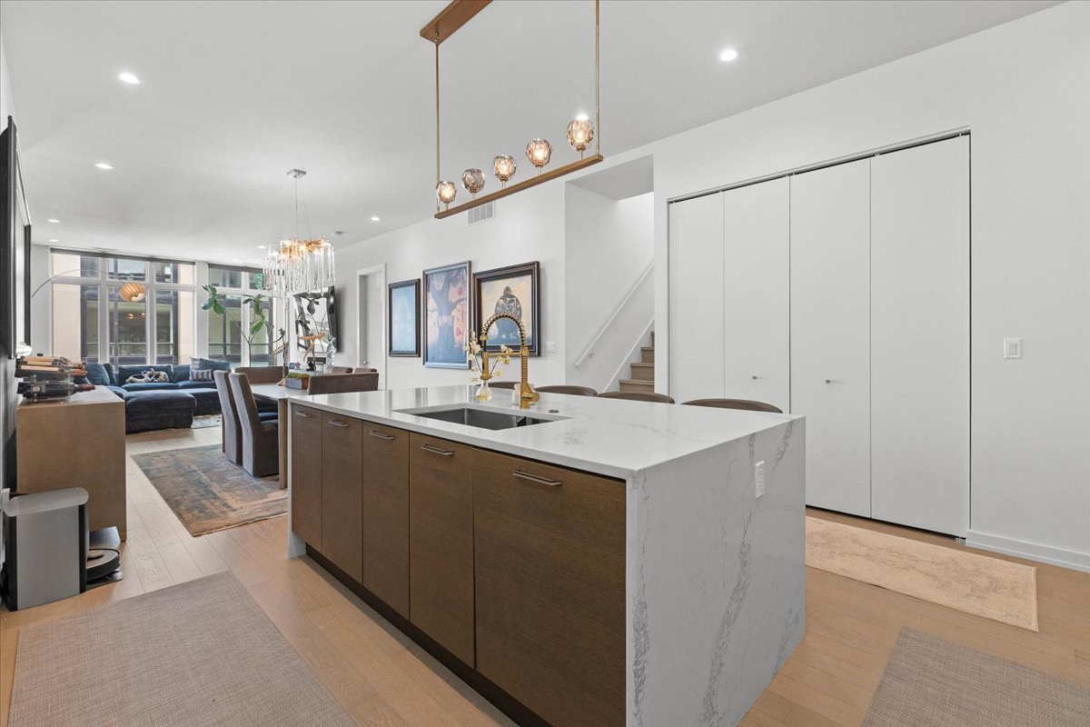 2773 North Hampden Court, Unit PH03 Chicago, IL 60614 - Photo 7 of 37 a view of kitchen with kitchen island a sink and a stove with wooden floor