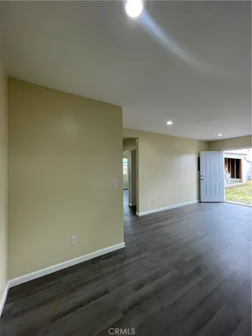 a large kitchen with a wooden floor and window