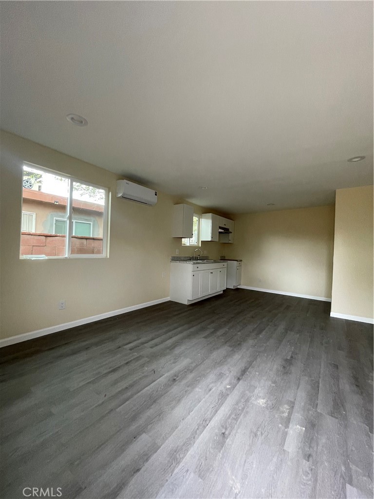 45124 Redwood Avenue Lancaster, CA 93534 - Photo 14 of 16 a view of an empty room with wooden floor and a window