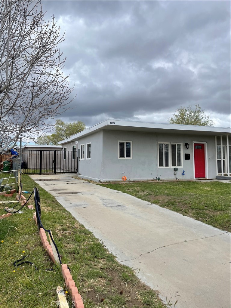 45124 Redwood Avenue Lancaster, CA 93534 - Photo 15 of 16 a front view of house with yard and trees around