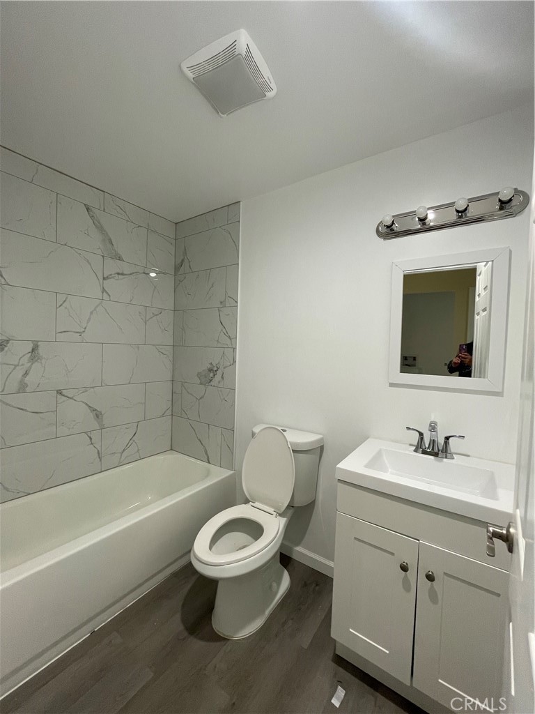 45124 Redwood Avenue Lancaster, CA 93534 - Photo 6 of 16 a bathroom with a toilet a sink a mirror and bathtub