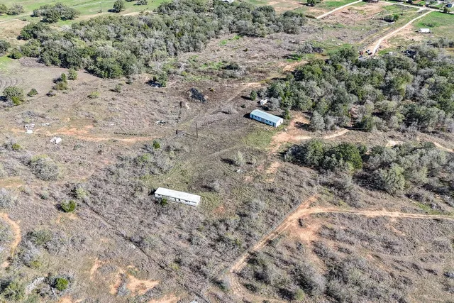 an aerial view of a houses with a yard