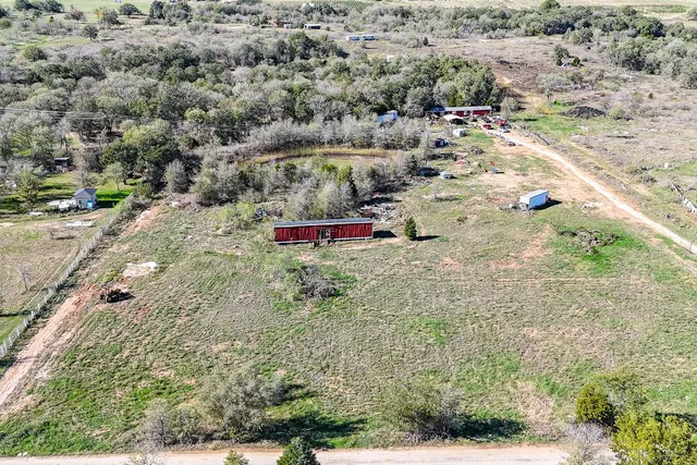 a aerial view of a house with a yard and lake view