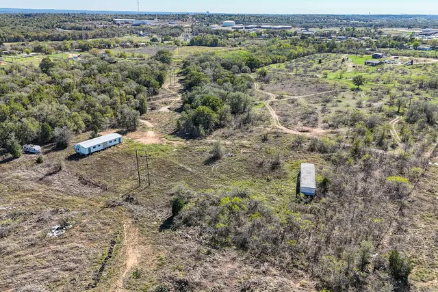 a view of a big yard with lots of bushes
