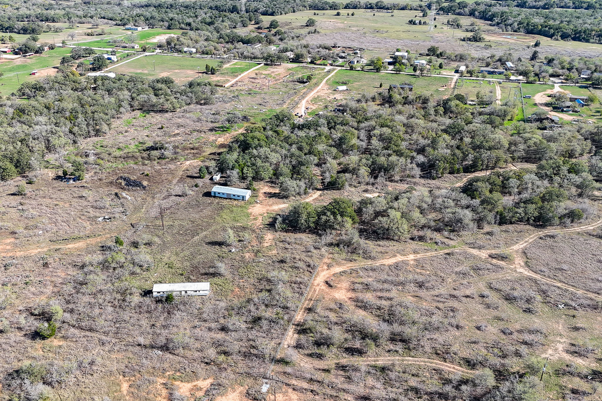 166 Norwood Lane Elgin, TX 78621 - Photo 10 of 22 a view of a dry yard with trees and houses