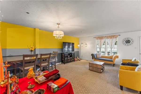 a living room with furniture dining table and a fireplace