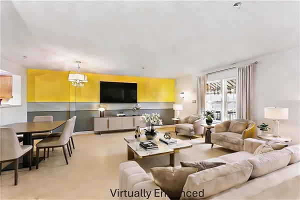 a living room with furniture wooden floor and a flat screen tv