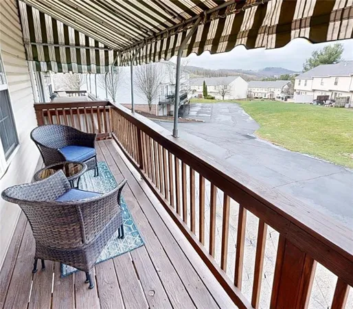 a view of balcony with wooden floor and outdoor seating
