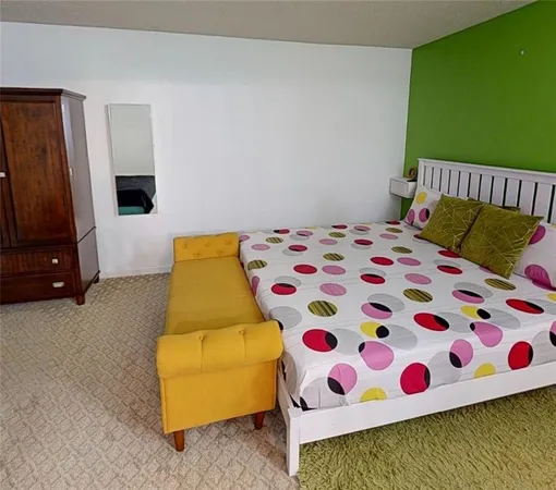 a bedroom with a bed and a chair