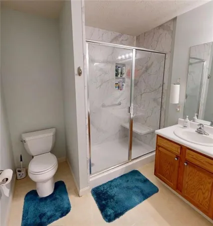 a bathroom with a double vanity sink mirror and shower