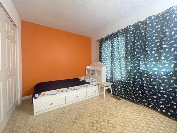 a bedroom with a bed and a chair