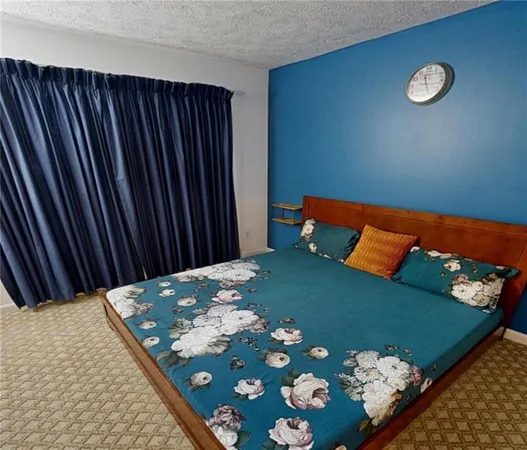 a bed sitting in a bedroom next to a window
