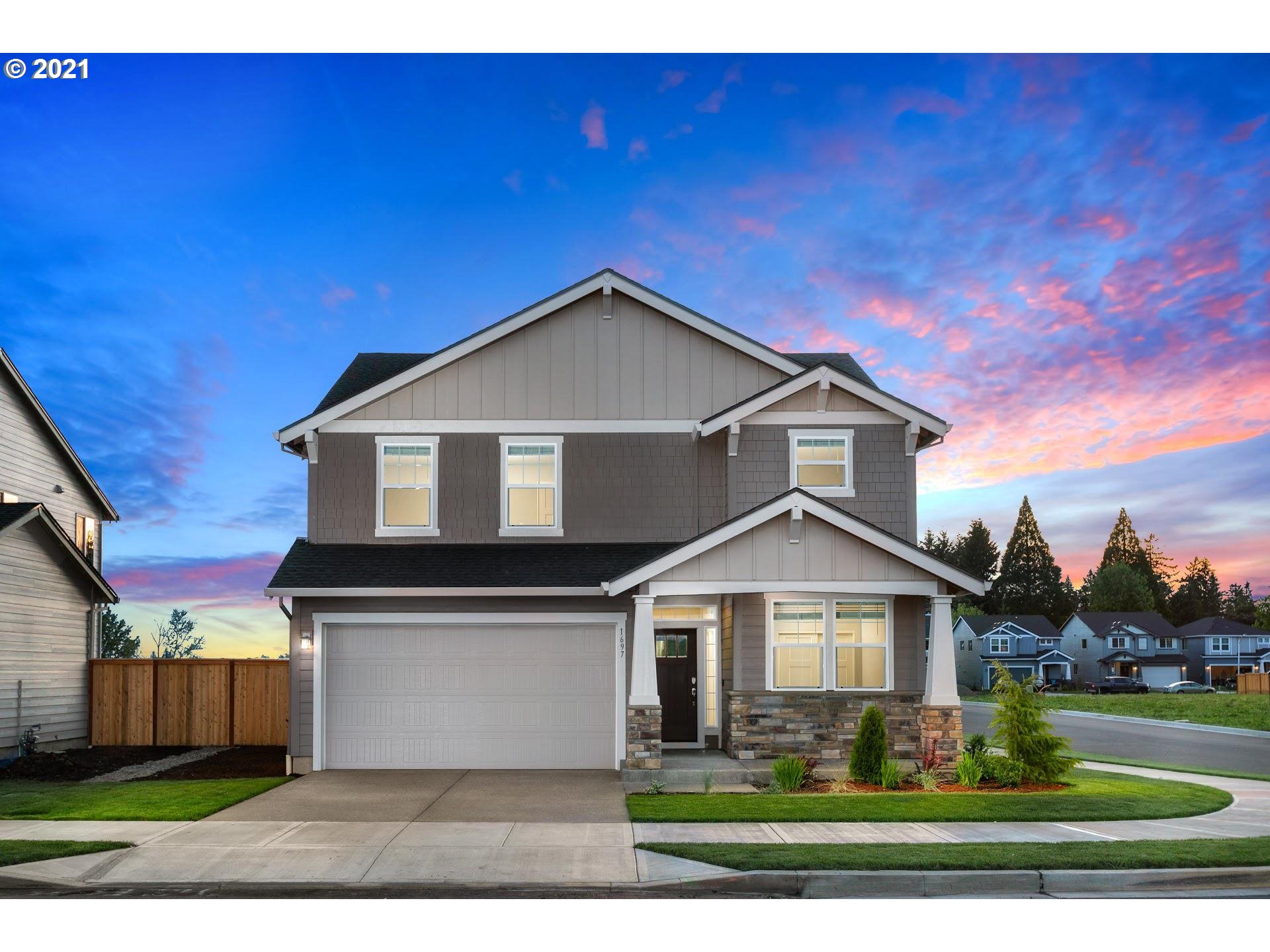 6800 North 89th Loop Camas, WA 98607 - Photo 1 of 24 a front view of a house with a yard and garage