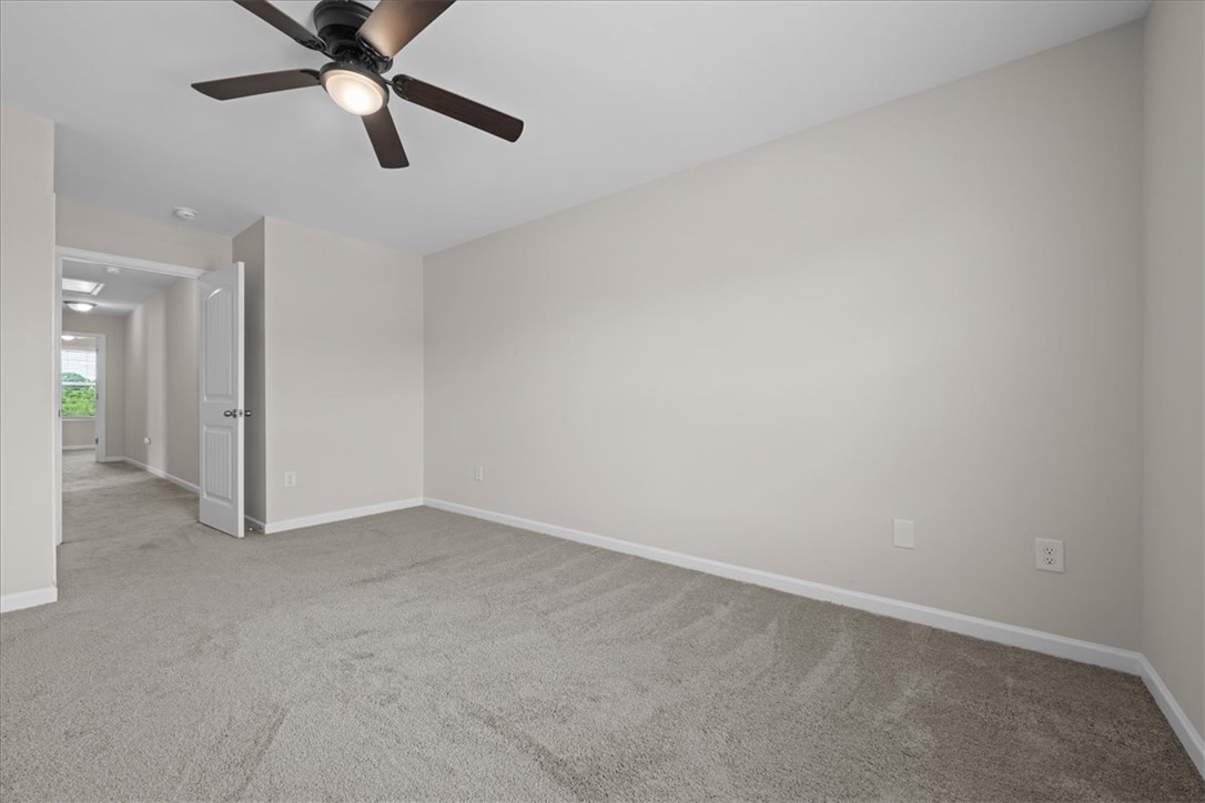 115 Adger Road Pendleton, SC 29670 - Photo 18 of 36 A quiet bedroom offers plush carpeting and a modern ceiling fan for comfort.
