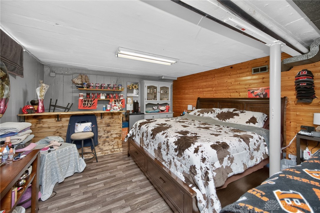 3301 Wildwood Road Middletown, OH 45042 - Photo 42 of 68 This cozy bedroom features durable wood paneling and practical flooring, creating a comfortable and inviting atmosphere.