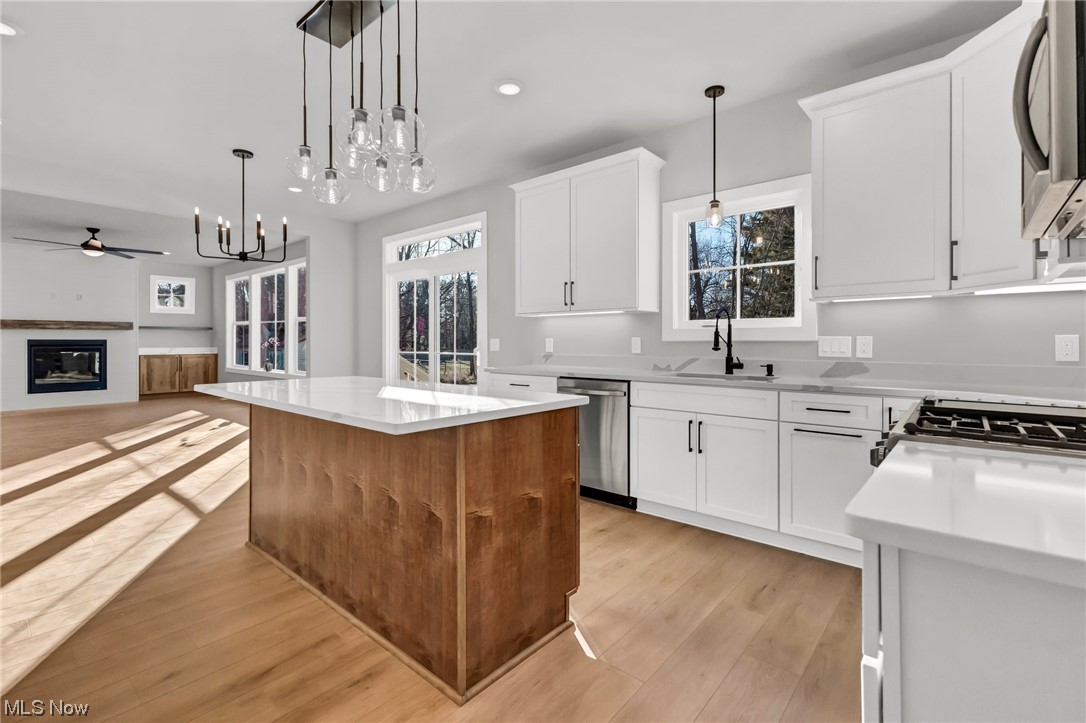 812 Ford Road Cleveland, OH 44143 - Photo 3 of 20 Kitchen featuring decorative light fixtures, light hardwood / wood-style flooring, and a kitchen island