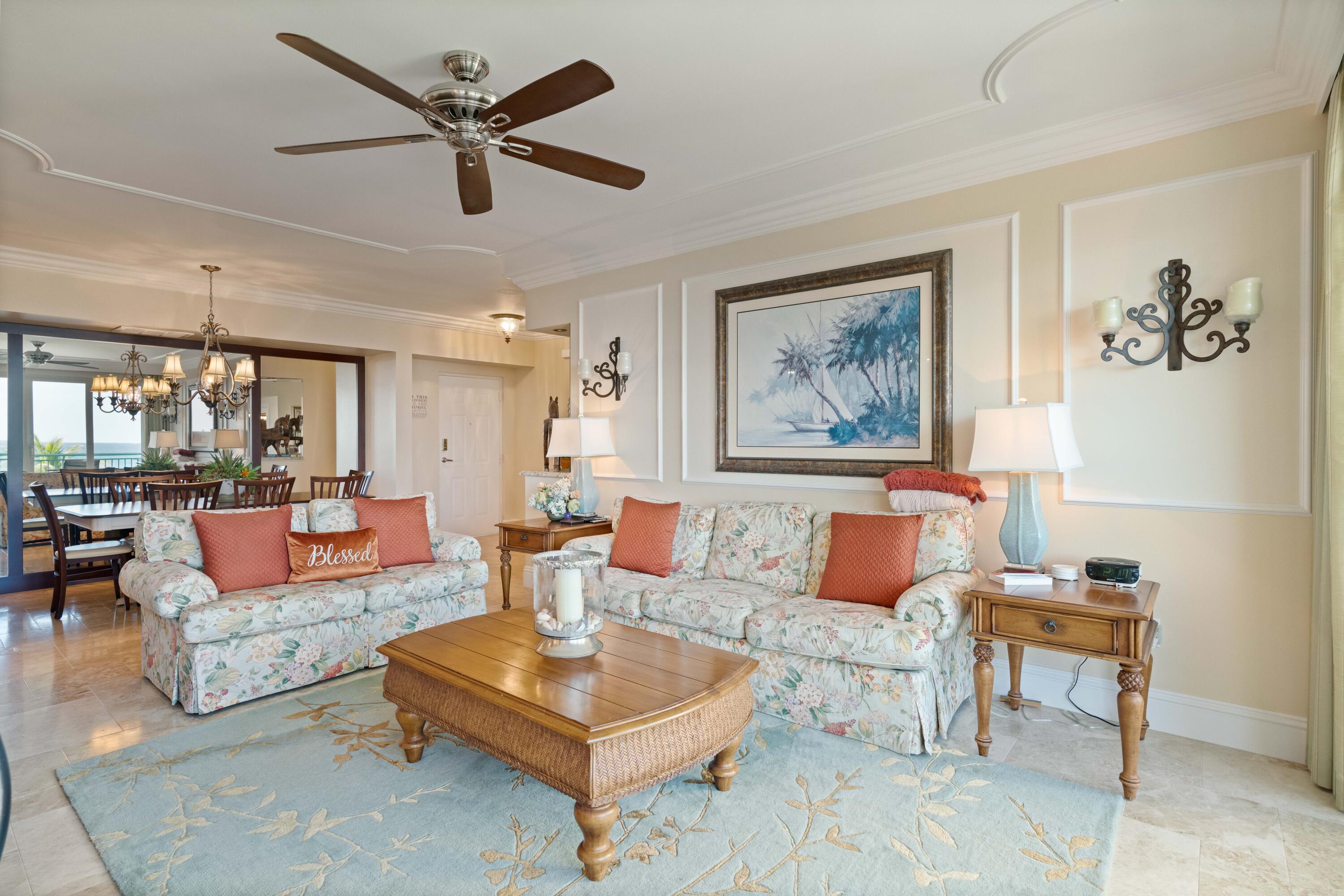 2000 Florida A1A, Unit 405 Jupiter, FL 33477 - Photo 13 of 39 a living room with furniture a rug and a ceiling fan