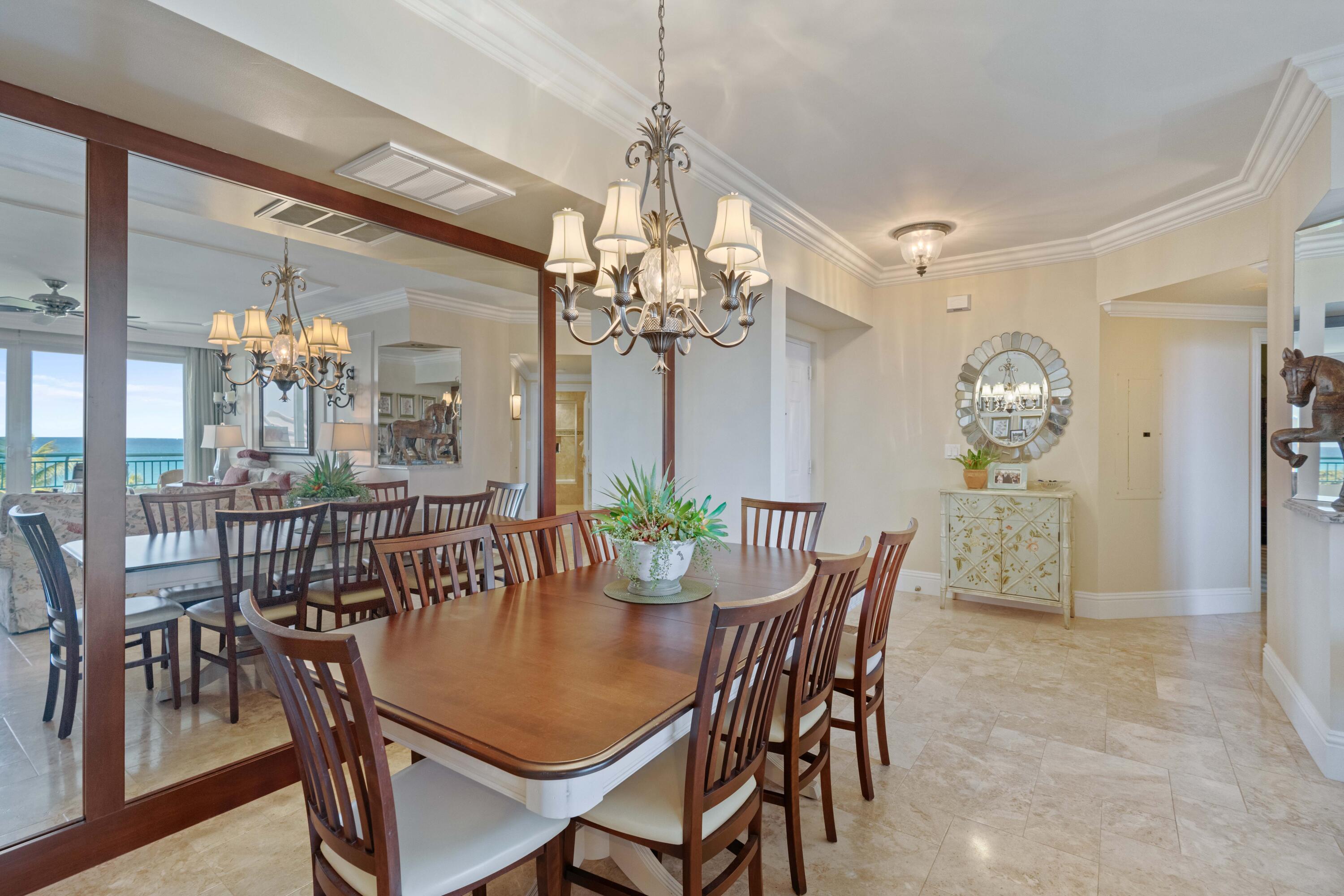 2000 Florida A1A, Unit 405 Jupiter, FL 33477 - Photo 14 of 39 a view of a dining room with furniture a chandelier and wooden floor