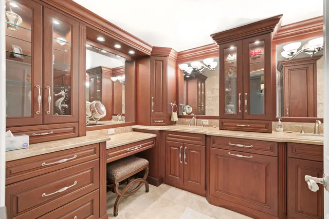 a bathroom with a granite countertop sink a toilet and shower