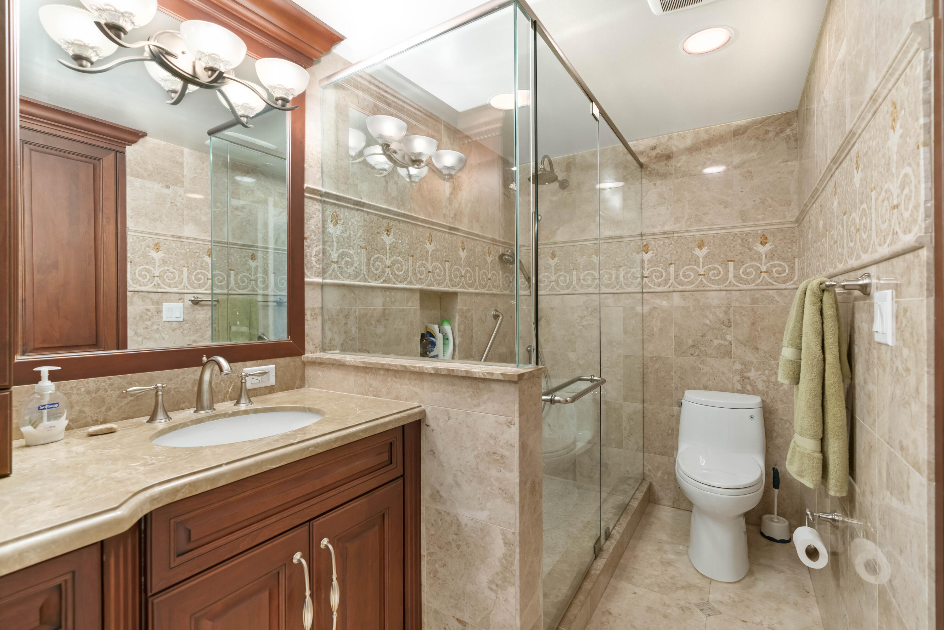 2000 Florida A1A, Unit 405 Jupiter, FL 33477 - Photo 19 of 39 a bathroom with a granite countertop sink a toilet and shower