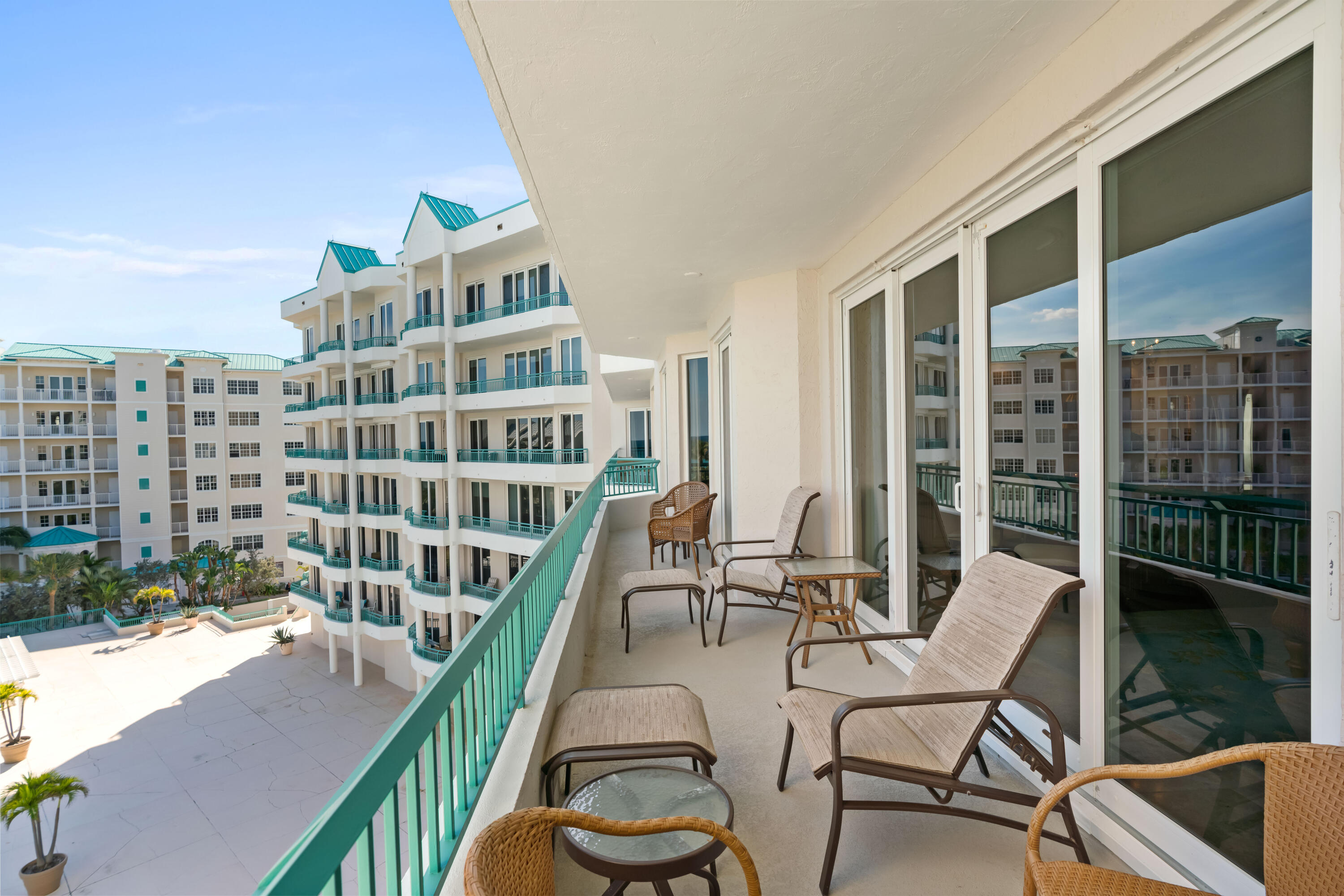 2000 Florida A1A, Unit 405 Jupiter, FL 33477 - Photo 23 of 39 a view of a balcony with two chairs and a potted plant