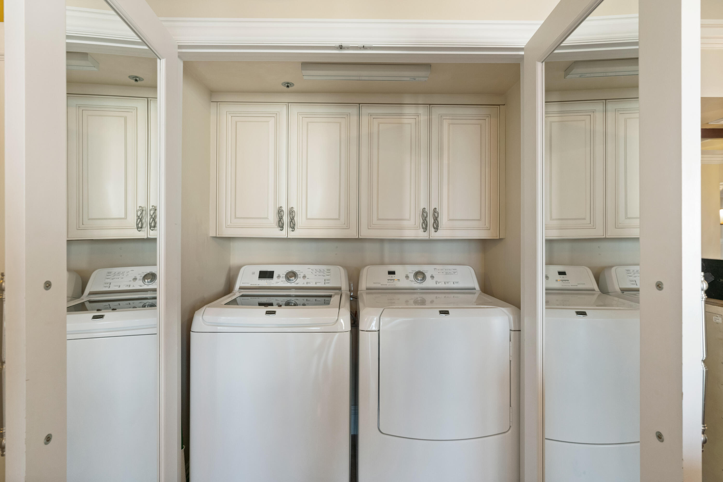 2000 Florida A1A, Unit 405 Jupiter, FL 33477 - Photo 25 of 39 a utility room with dryer washer and a fridge