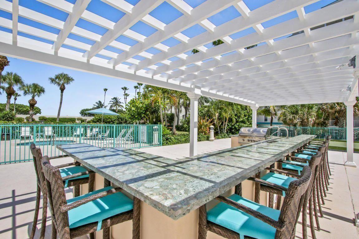 2000 Florida A1A, Unit 405 Jupiter, FL 33477 - Photo 36 of 39 a view of an outside dining space with furniture