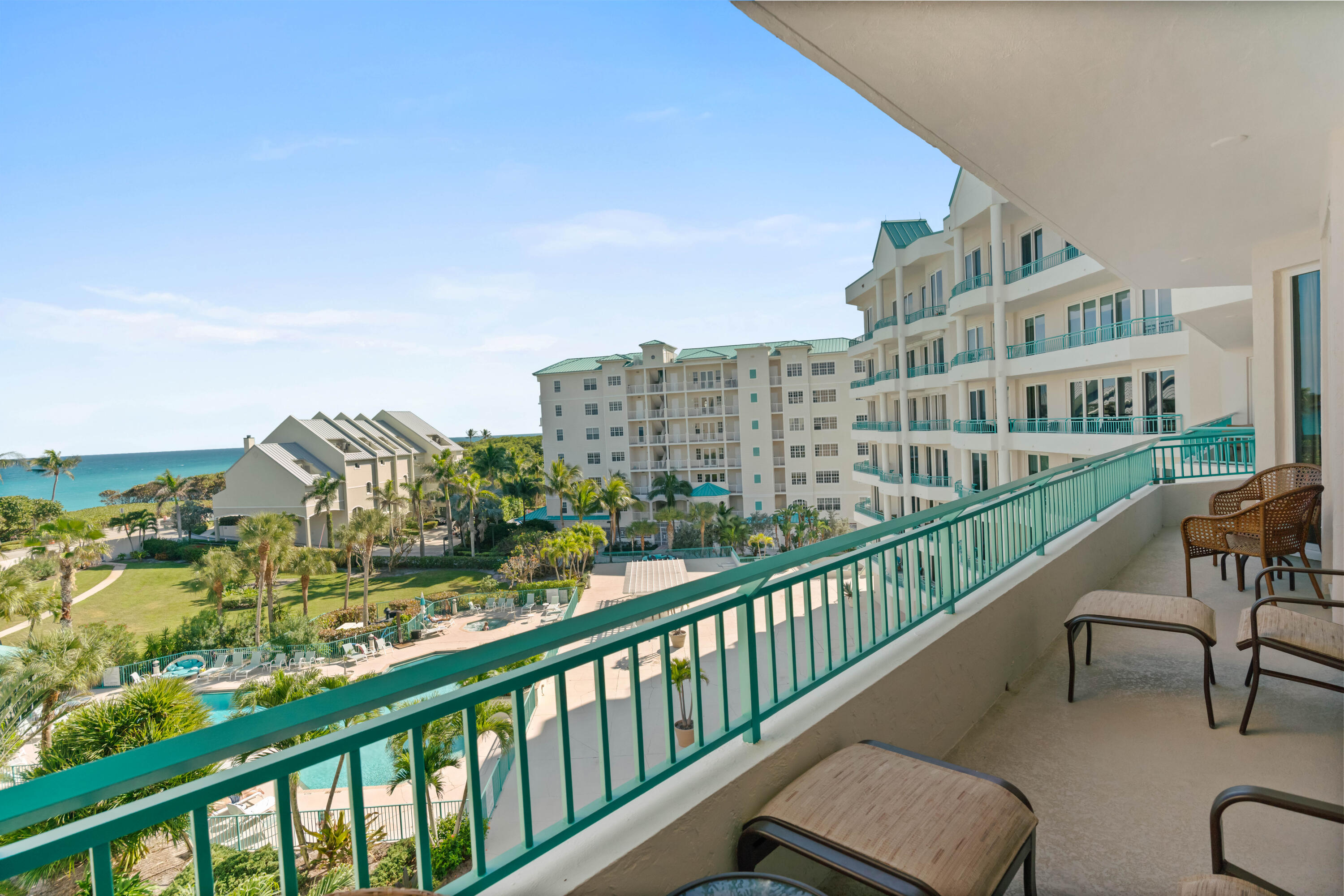 2000 Florida A1A, Unit 405 Jupiter, FL 33477 - Photo 8 of 39 a view of a city from a balcony with chairs