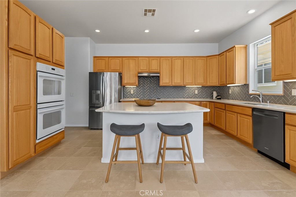 1706 Brittney Road Beaumont, CA 92223 - Photo 12 of 44 a kitchen with a sink cabinets and window