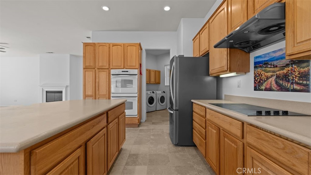 1706 Brittney Road Beaumont, CA 92223 - Photo 14 of 44 a kitchen with stainless steel appliances granite countertop a refrigerator and a sink