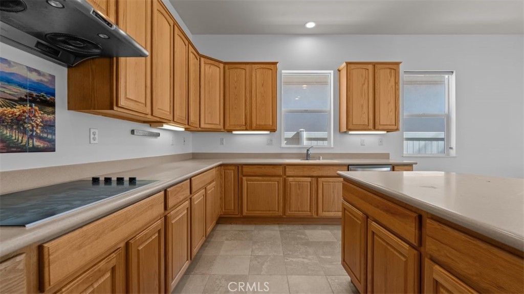 1706 Brittney Road Beaumont, CA 92223 - Photo 15 of 44 a kitchen with stainless steel appliances granite countertop a sink stove and cabinets